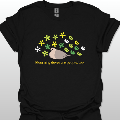 Black t-shirt with a graphic of a dove and flowers, text 'Mourning doves are people too.' on a white background
