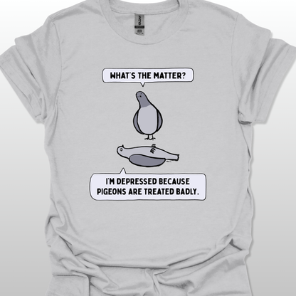 Grey t-shirt with a graphic of two pigeons saying, "What's the matter?" "I'm depressed because pigeons are treated badly." on a white background