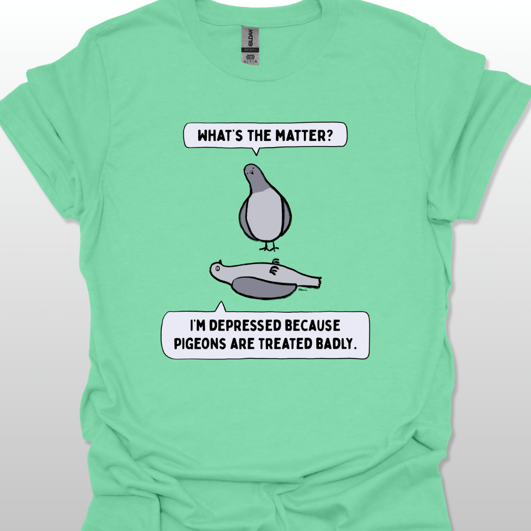 Blue t-shirt with a graphic of two pigeons saying, "What's the matter?" "I'm depressed because pigeons are treated badly." on a white background