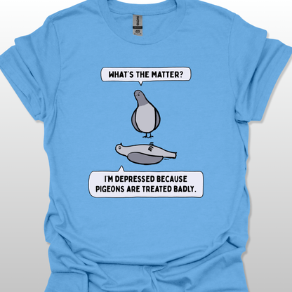 Blue t-shirt with a graphic of two pigeons saying, "What's the matter?" "I'm depressed because pigeons are treated badly." on a white background
