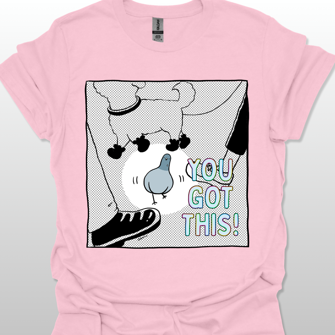 Pink t-shirt with a graphic design of a pigeon and text 'YOU GOT THIS!' on a light gray background