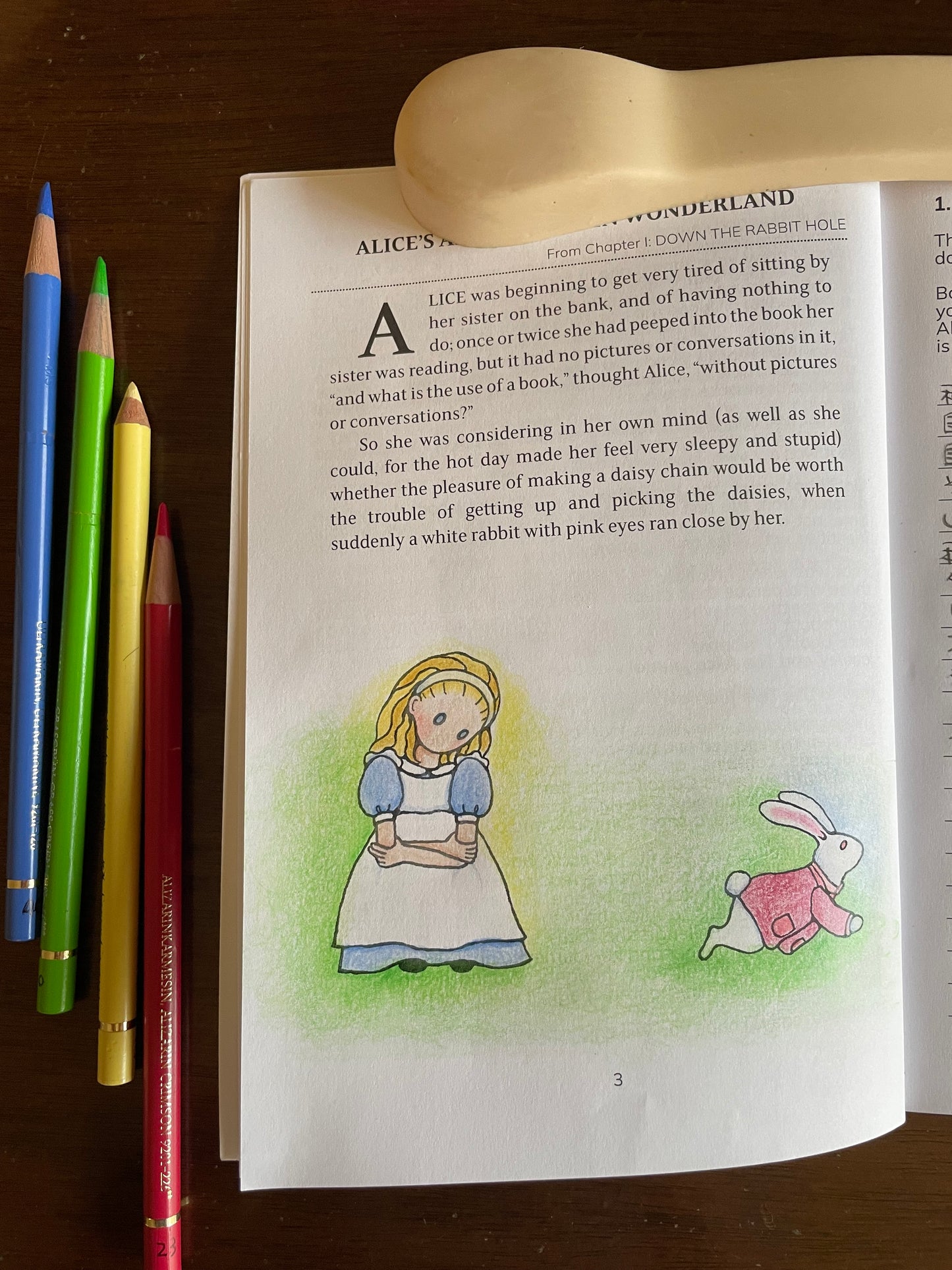 A page of The Alice Journal colored with colored pencils 