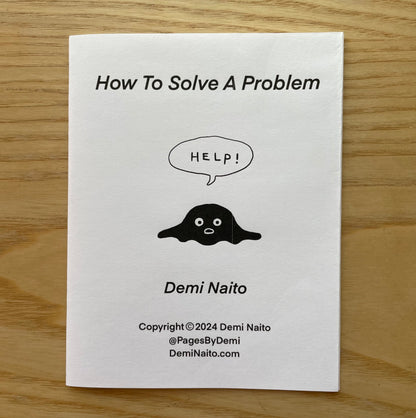 Cover of 'How To Solve A Problem' zine by Demi Naito featuring black blob cartoon character calling for help.