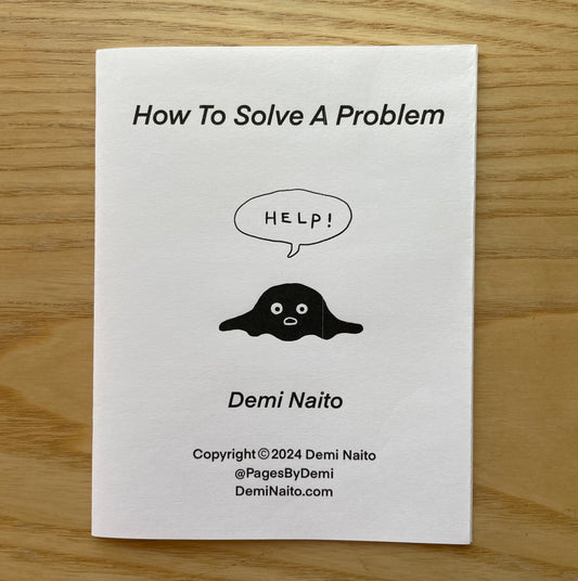 Cover of 'How To Solve A Problem' zine by Demi Naito featuring black blob cartoon character calling for help.