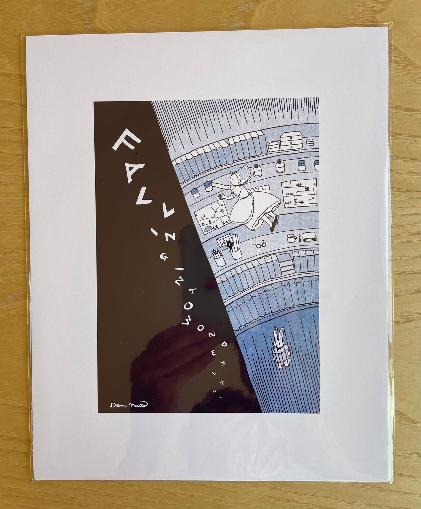 Falling Into Wonderland print with a scene of Alice falling into a well after the white rabbit.